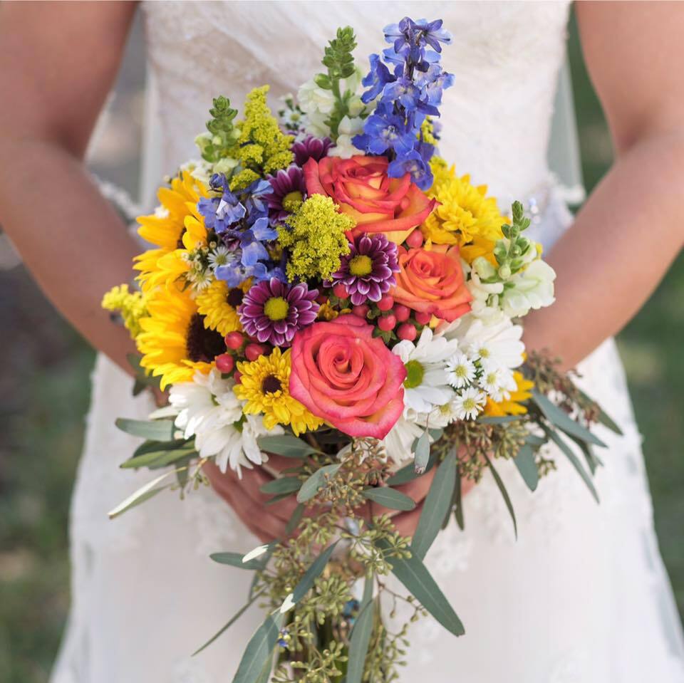 Colorful bridal bouquet with sunflowers and roses