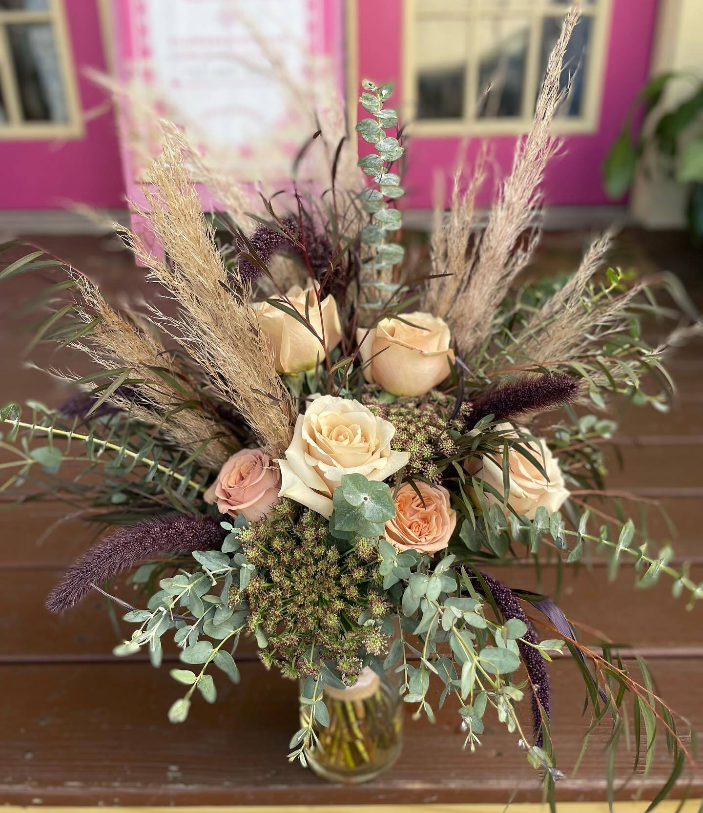 Boho arrangement of blush roses, pampas grass and eucalyptus